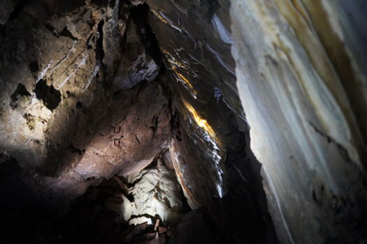LED light accents on natural rock formations in Herrmann’s Cave